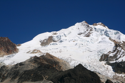 huayna potosi, picture 3: high camp barely visible on the small left-hand rock half-way up. click on the image to go to the next picture